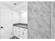 A bathroom has marble tiled showers and a storage cabinet at 5927 10Th N St, St Petersburg, FL 33703