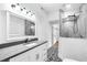 Elegant bathroom with patterned tile floor, stone countertop, glass shower, and a walk-in closet at 5927 10Th N St, St Petersburg, FL 33703