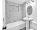 A well lit renovated bathroom with a marble tiled shower at 5927 10Th N St, St Petersburg, FL 33703
