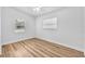 This bedroom features a ceiling fan and a window with wood-look flooring at 5927 10Th N St, St Petersburg, FL 33703