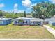 Charming single-story home featuring a well-maintained front yard, quaint entry way, and lush landscaping at 5927 10Th N St, St Petersburg, FL 33703