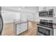 Modern kitchen with stainless steel appliances, quartz countertops, and island with bar stool seating at 5927 10Th N St, St Petersburg, FL 33703