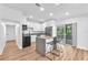 Modern kitchen with stainless steel appliances, quartz countertops, and island with bar stool seating at 5927 10Th N St, St Petersburg, FL 33703
