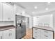 Modern kitchen with stainless steel appliances, quartz countertops, and white cabinetry at 5927 10Th N St, St Petersburg, FL 33703