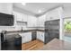 Modern kitchen with stainless steel appliances, quartz countertops, and white cabinetry at 5927 10Th N St, St Petersburg, FL 33703