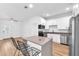Modern kitchen with stainless steel appliances, quartz countertops, and island with bar stool seating at 5927 10Th N St, St Petersburg, FL 33703