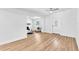 Bright living room featuring wood floors, a decorative front door, and a stone fireplace at 5927 10Th N St, St Petersburg, FL 33703