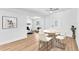 Decorated open-concept room showcasing new floors, modern lighting, and a fireplace with a stone surround at 5927 10Th N St, St Petersburg, FL 33703