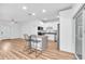 The open living room has new floors and a stylish kitchen island with seating at 5927 10Th N St, St Petersburg, FL 33703