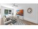 Modern living room with a large TV, sliding glass doors, and a view of the pool at 5927 10Th N St, St Petersburg, FL 33703