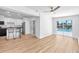 Open living space with hardwood floors and sliding glass doors leading to the pool area at 5927 10Th N St, St Petersburg, FL 33703