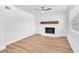 Living room featuring hardwood floors and a stone fireplace with wooden mantel at 5927 10Th N St, St Petersburg, FL 33703
