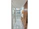 Bright bathroom with marble floors, shower, built in storage, and glass shower door at 6424 Thicket Trl, New Port Richey, FL 34653