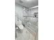 Bathroom with marble floors and shower with glass door at 6424 Thicket Trl, New Port Richey, FL 34653