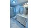 Bathroom with a shower with a glass door and a double sink vanity at 6424 Thicket Trl, New Port Richey, FL 34653
