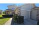 Charming home featuring a two-car garage, brick accents, and well-maintained landscaping at 6424 Thicket Trl, New Port Richey, FL 34653