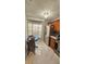 Bright kitchen nook with stainless steel refrigerator and white marble floor at 6424 Thicket Trl, New Port Richey, FL 34653