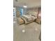 Main bedroom with a tufted headboard and marble flooring at 6424 Thicket Trl, New Port Richey, FL 34653