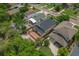 View of the property from above, surrounded by lush greenery and a wooden deck in the backyard at 6625 Interbay Blvd, Tampa, FL 33611