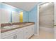 Bathroom featuring double sinks, a large mirror, and a shower/tub combo in a connecting room at 6625 Interbay Blvd, Tampa, FL 33611