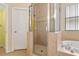 Bathroom showcasing a tiled shower, soaking tub, and neutral tones at 6625 Interbay Blvd, Tampa, FL 33611