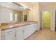 Spacious bathroom featuring double sinks, a large mirror, and a walk-in shower at 6625 Interbay Blvd, Tampa, FL 33611