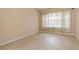 Bright bedroom featuring neutral walls, tile flooring, and a large window that offers ample natural light at 6625 Interbay Blvd, Tampa, FL 33611