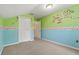 Cozy bedroom with flower decal, carpet, and a double door closet at 6625 Interbay Blvd, Tampa, FL 33611
