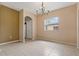 Formal dining room with tile flooring, a chandelier, and a window overlooking the backyard area at 6625 Interbay Blvd, Tampa, FL 33611