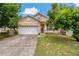 Charming two-story home with a well-maintained lawn, inviting curb appeal, and attached two-car garage at 6625 Interbay Blvd, Tampa, FL 33611