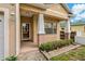 Inviting front porch featuring classic columns and brick accents, perfect for enjoying the outdoors at 6625 Interbay Blvd, Tampa, FL 33611