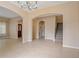 Spacious living room featuring tile floors, archways, and a staircase leading to the upper level at 6625 Interbay Blvd, Tampa, FL 33611