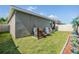 A well-maintained backyard has a cozy outdoor dining area and partial view of the home's exterior at 7414 Indigo Oasis Ct, Gibsonton, FL 33534