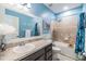 Bright bathroom with vanity and bathtub with shower, and nautical decor at 7414 Indigo Oasis Ct, Gibsonton, FL 33534
