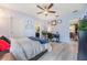Bright primary bedroom with ceiling fan, ensuite bathroom and views to dining area at 7414 Indigo Oasis Ct, Gibsonton, FL 33534
