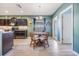 Cozy dining area adjacent to the kitchen, featuring warm lighting and a view of the backyard at 7414 Indigo Oasis Ct, Gibsonton, FL 33534