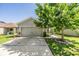 Charming one-story home with a well-manicured lawn and a two-car garage at 7414 Indigo Oasis Ct, Gibsonton, FL 33534