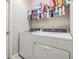 Convenient laundry room with washer, dryer, and storage shelf for supplies at 7414 Indigo Oasis Ct, Gibsonton, FL 33534