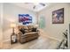 Cozy living room with a sofa and natural light from the window at 7414 Indigo Oasis Ct, Gibsonton, FL 33534