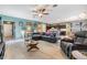 Spacious open-concept living area with a large sectional and breakfast bar in the kitchen at 7414 Indigo Oasis Ct, Gibsonton, FL 33534