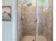 Close-up of tiled shower with glass door and modern fixtures at 7414 Indigo Oasis Ct, Gibsonton, FL 33534