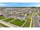 Aerial view of a community of light gray and tan homes with green lawns at 7641 Sail Clover Ln, Zephyrhills, FL 33540