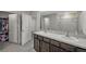 A full bathroom with dual sinks, a shower, and a closet at 7641 Sail Clover Ln, Zephyrhills, FL 33540
