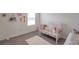 Charming Bedroom room with crib, decorative accents, and soft, inviting decor at 7641 Sail Clover Ln, Zephyrhills, FL 33540