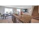 Modern kitchen island with a stainless steel sink, granite countertop, and seating at 7641 Sail Clover Ln, Zephyrhills, FL 33540