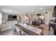 Bright open-concept living area featuring a modern kitchen, dining space, and comfortable seating at 7641 Sail Clover Ln, Zephyrhills, FL 33540