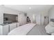 A spacious main bedroom with simple decor, lots of natural light, and a television at 7641 Sail Clover Ln, Zephyrhills, FL 33540