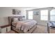 Bright main bedroom with neutral decor, comfortable queen bed, and ample natural light at 7641 Sail Clover Ln, Zephyrhills, FL 33540