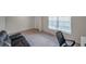A cozy and functional office space with a comfortable couch, desk, and natural light at 7641 Sail Clover Ln, Zephyrhills, FL 33540