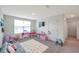 Large playroom featuring a comfortable couch, flat screen TV, toy kitchen, and play area at 7641 Sail Clover Ln, Zephyrhills, FL 33540